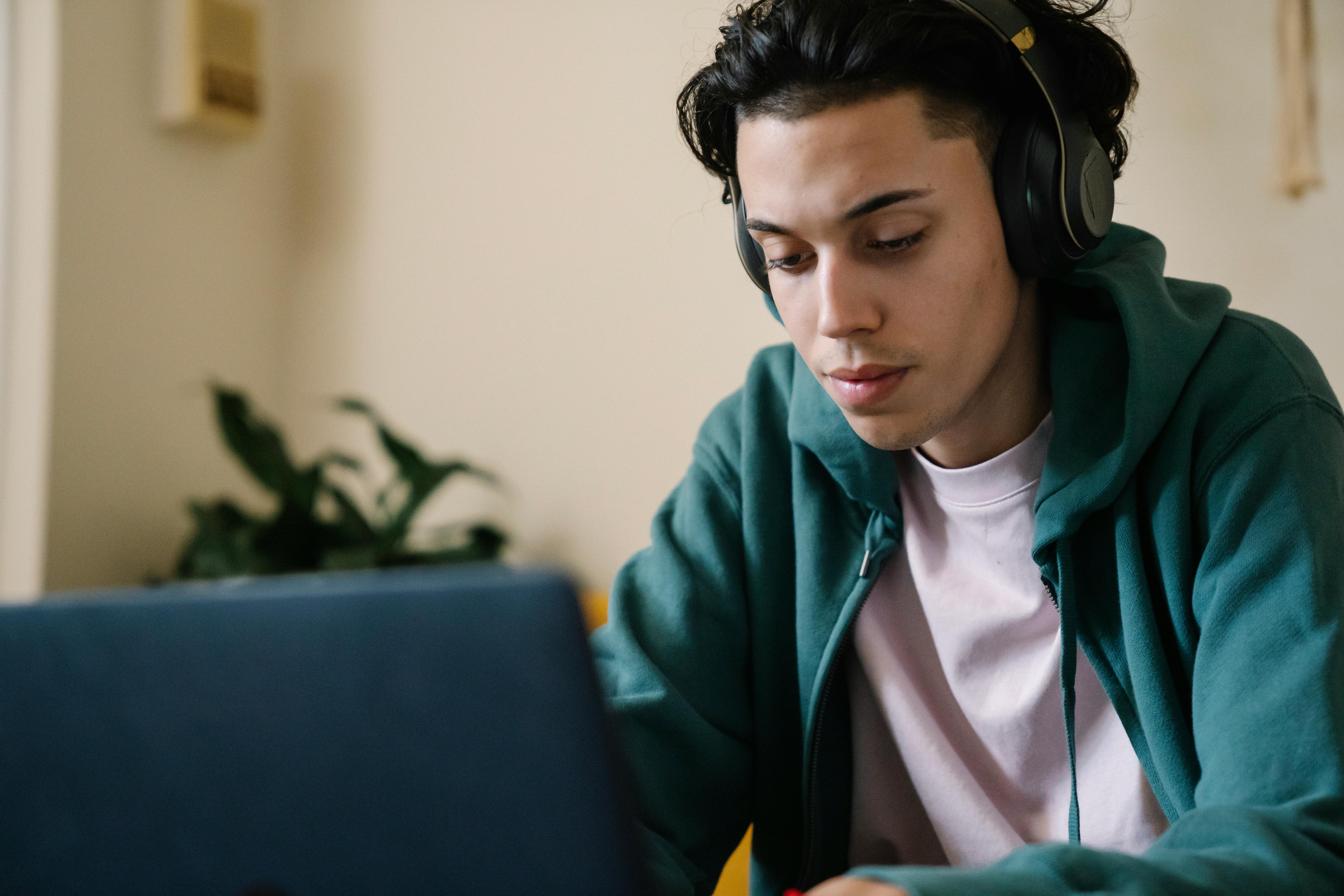 A young man using a laptop computer.